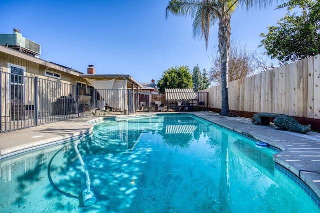 view of swimming pool featuring central AC unit