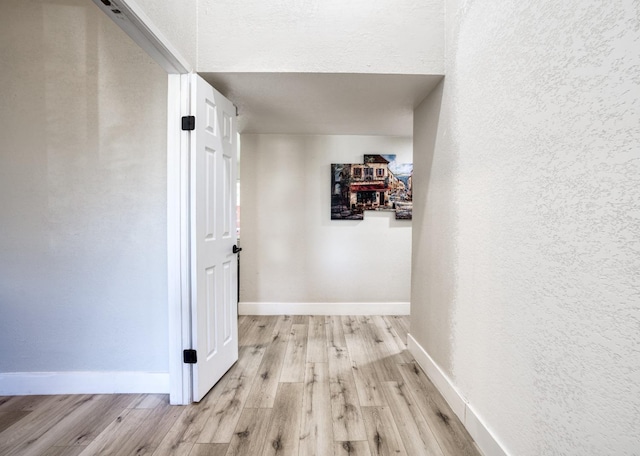 corridor featuring light hardwood / wood-style flooring