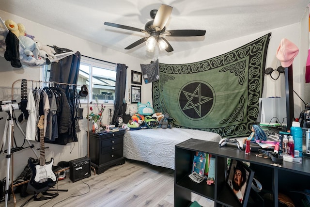 bedroom with light hardwood / wood-style flooring and ceiling fan