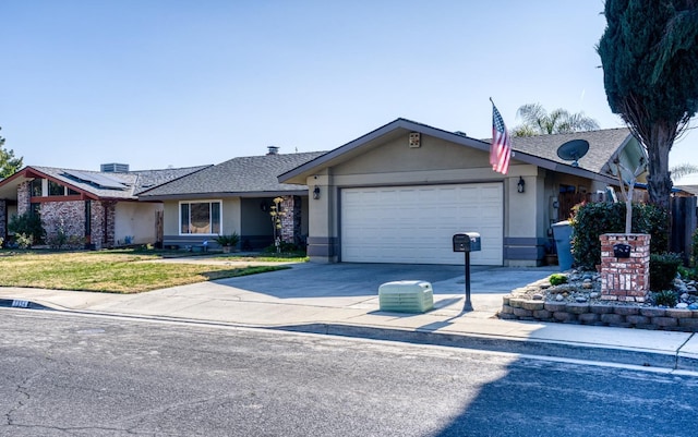 ranch-style house featuring a garage, a front yard, and solar panels