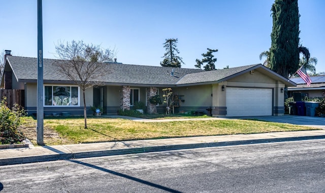 ranch-style house featuring a garage and a front lawn