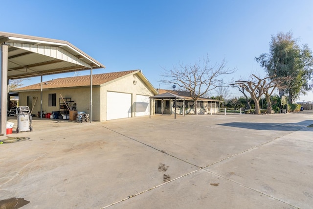 view of side of property with a garage and a gazebo