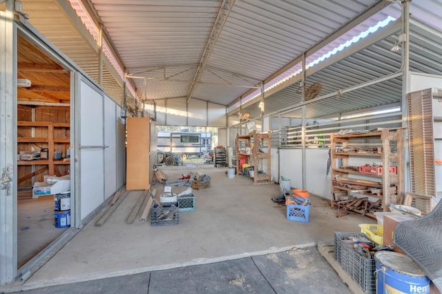 misc room featuring lofted ceiling and concrete flooring