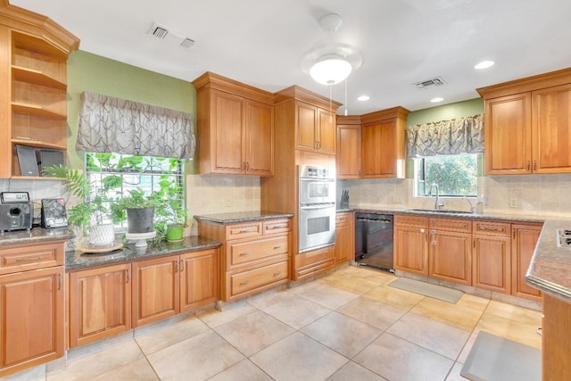 kitchen featuring double oven, black dishwasher, sink, decorative backsplash, and light tile patterned floors