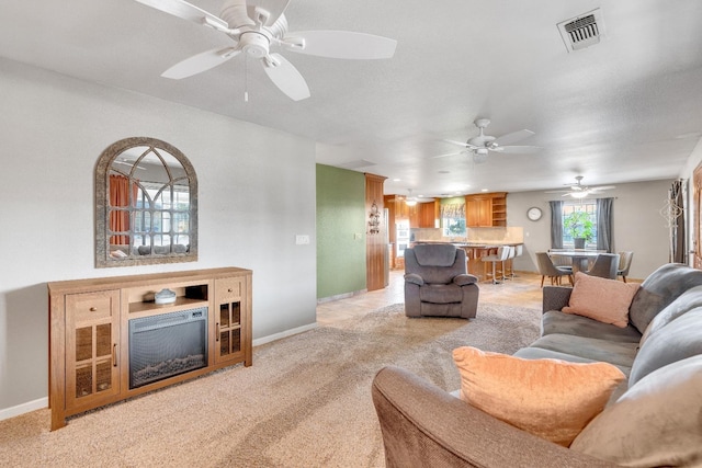 living room with light carpet and ceiling fan