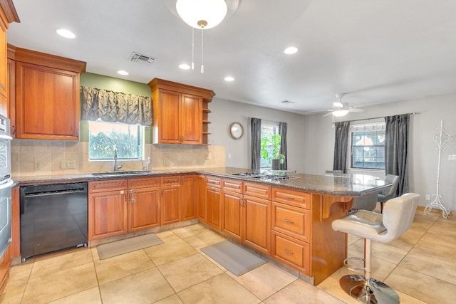 kitchen with stainless steel appliances, backsplash, a kitchen breakfast bar, and kitchen peninsula