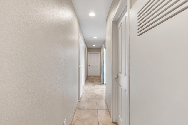 hall featuring light tile patterned floors