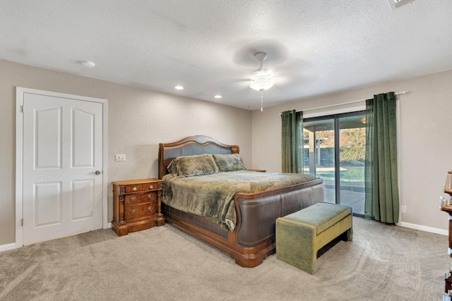 carpeted bedroom with access to outside, a textured ceiling, and ceiling fan