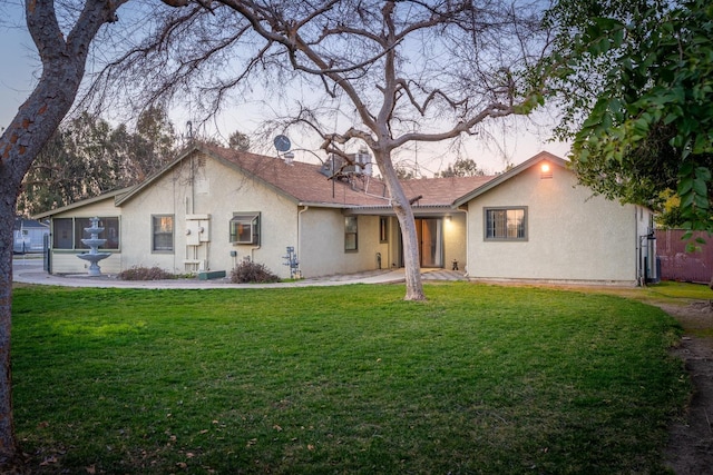 ranch-style home featuring a yard