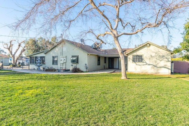 rear view of house with a lawn