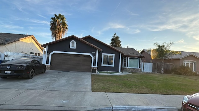 ranch-style house with a garage and a front lawn