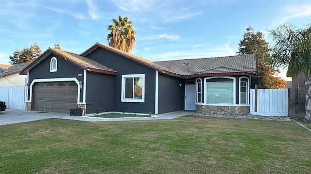 ranch-style home with a garage and a front yard