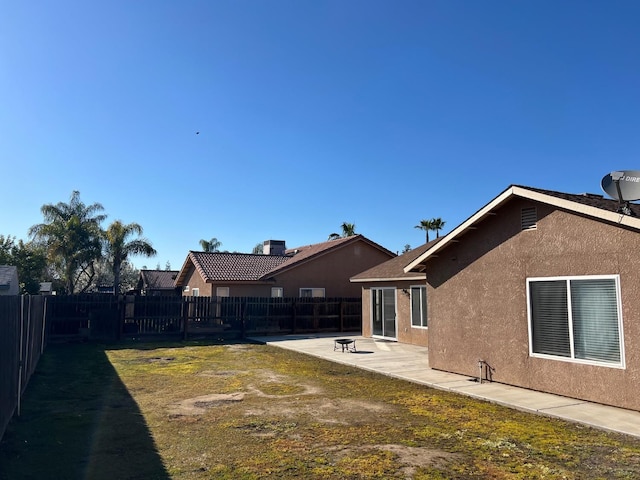 back of property with a patio area, a fenced backyard, and stucco siding