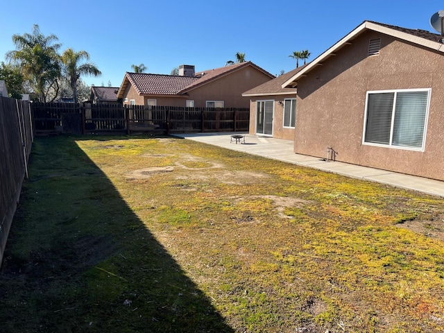 2882 Plumas St, Madera, CA 93637 - rear view of property with a fenced backyard, a patio area, stucco siding, and a yard
