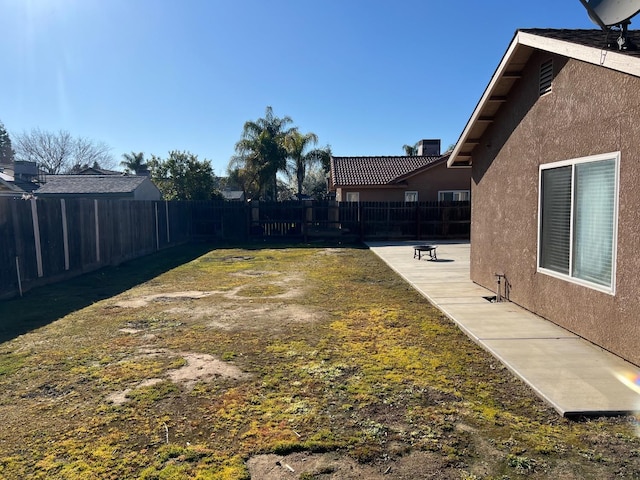 view of yard with a patio area and a fenced backyard