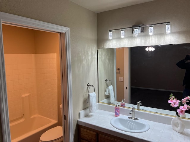 bathroom with shower / bathing tub combination, vanity, and toilet