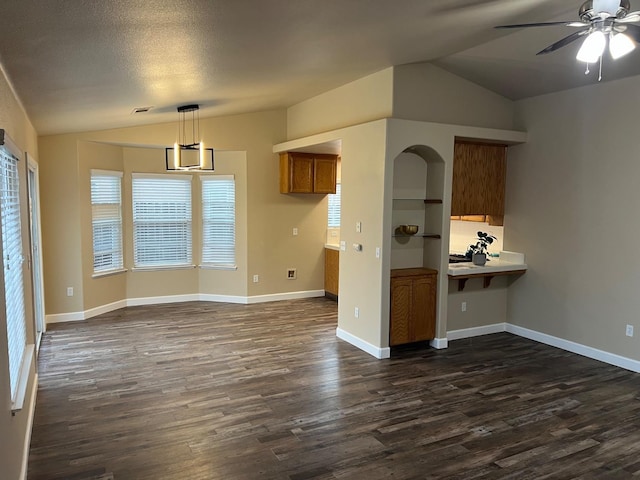 interior space with dark wood-style floors, lofted ceiling, and visible vents