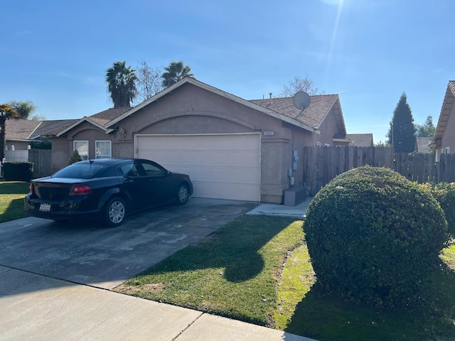 view of front of home with a garage, concrete driveway, fence, and stucco siding