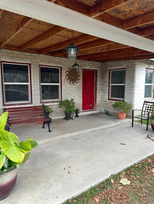 view of exterior entry featuring a patio area