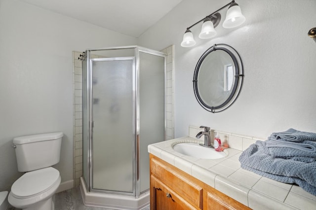 bathroom with a shower with door, vanity, and toilet