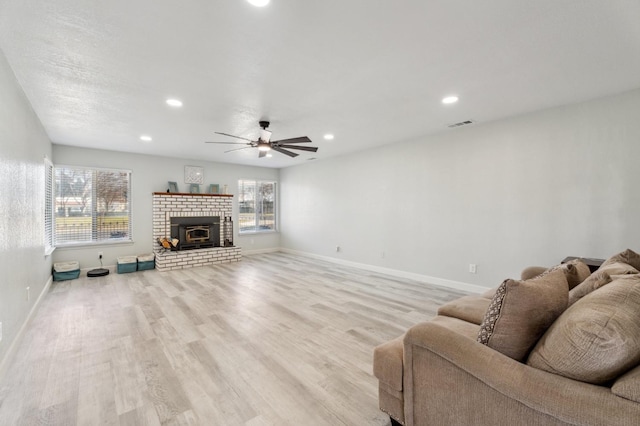 living room featuring ceiling fan and light wood-type flooring