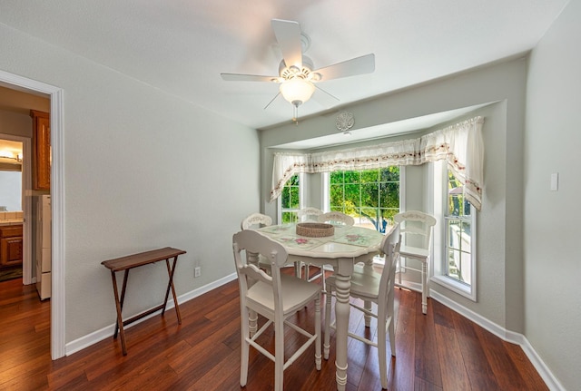 dining space with ceiling fan, wood-type flooring, and baseboards