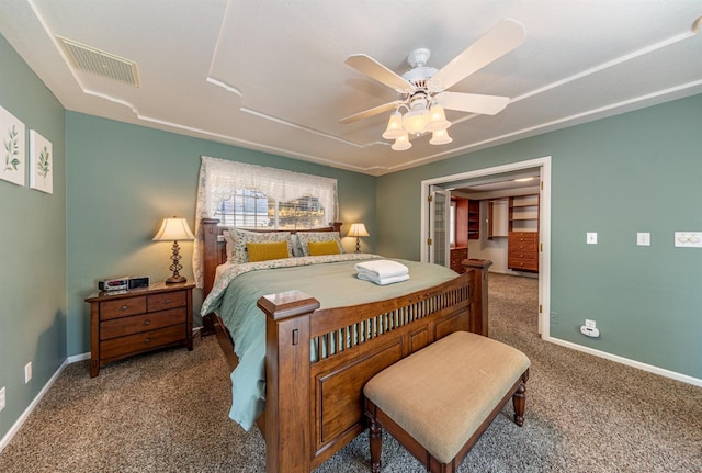 carpeted bedroom featuring a ceiling fan, visible vents, and baseboards