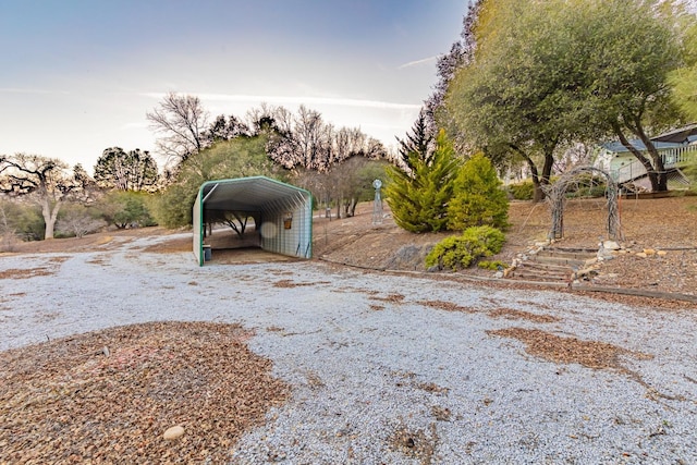 view of yard featuring driveway and a carport