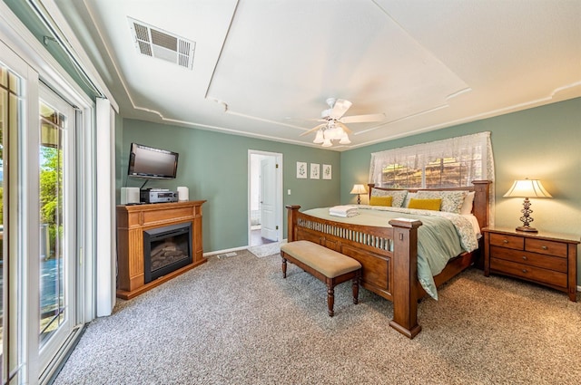 bedroom featuring a fireplace, visible vents, a ceiling fan, access to outside, and carpet