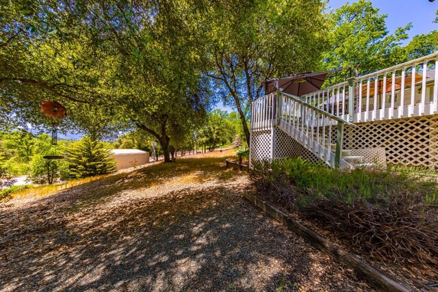 view of yard featuring stairway and a deck