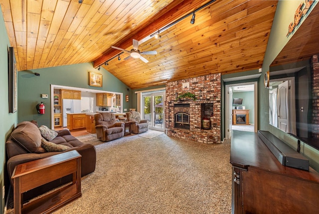 carpeted living area featuring lofted ceiling with beams, wood ceiling, and a fireplace