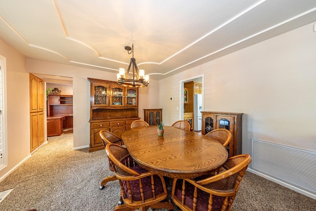 dining room featuring light carpet, baseboards, visible vents, and a notable chandelier