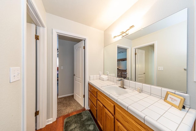 bathroom with wood finished floors and vanity