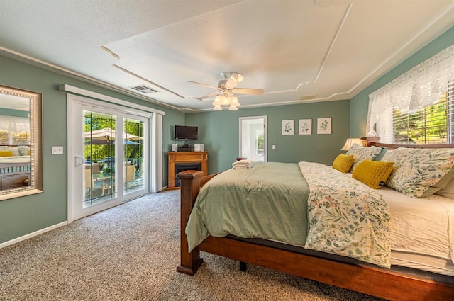 bedroom featuring carpet floors, a fireplace, visible vents, a ceiling fan, and access to outside