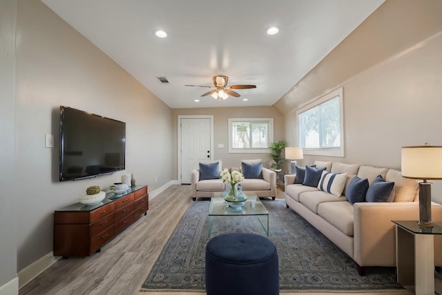 living room with light hardwood / wood-style flooring and ceiling fan