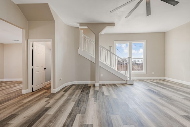 unfurnished living room with hardwood / wood-style flooring and ceiling fan