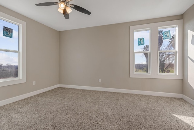 unfurnished room featuring carpet, a healthy amount of sunlight, and ceiling fan