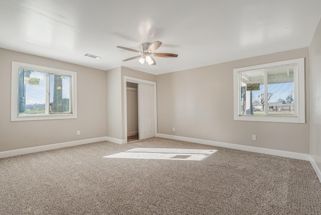 unfurnished bedroom with a closet, ceiling fan, and carpet