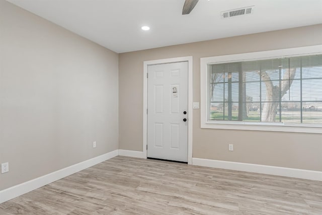 foyer entrance with ceiling fan and light wood-type flooring