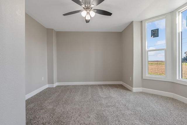 empty room featuring carpet floors and ceiling fan