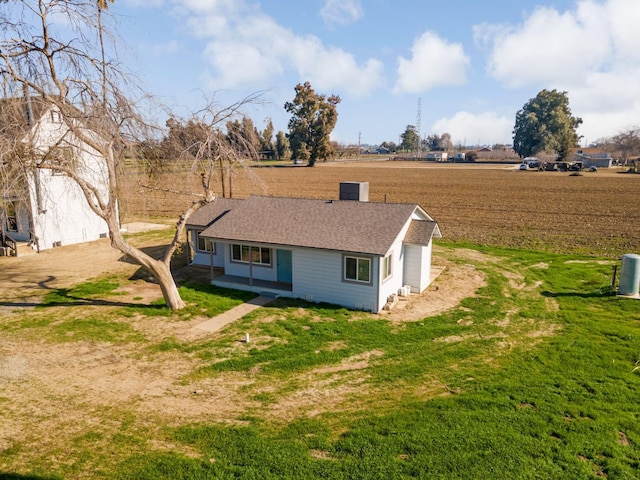 exterior space featuring a rural view and a yard