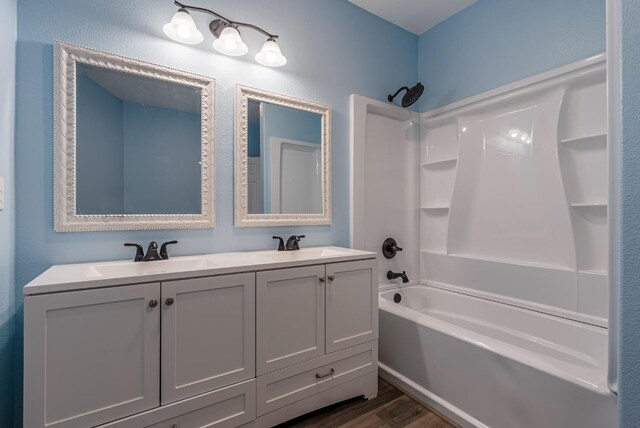 bathroom featuring vanity, hardwood / wood-style floors, and tub / shower combination