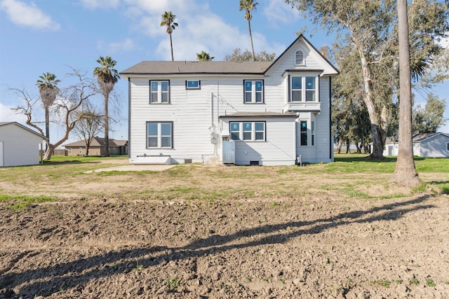 rear view of property with a yard