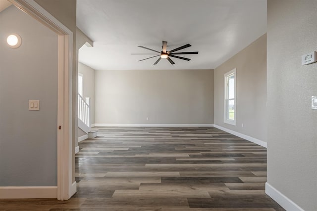 unfurnished room featuring ceiling fan and dark hardwood / wood-style flooring