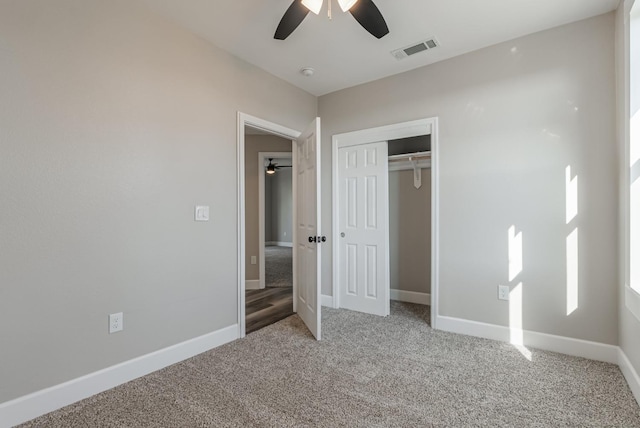 unfurnished bedroom with carpet floors, a closet, and ceiling fan