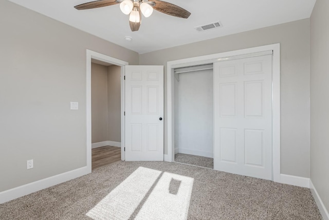 unfurnished bedroom featuring ceiling fan, carpet flooring, and a closet