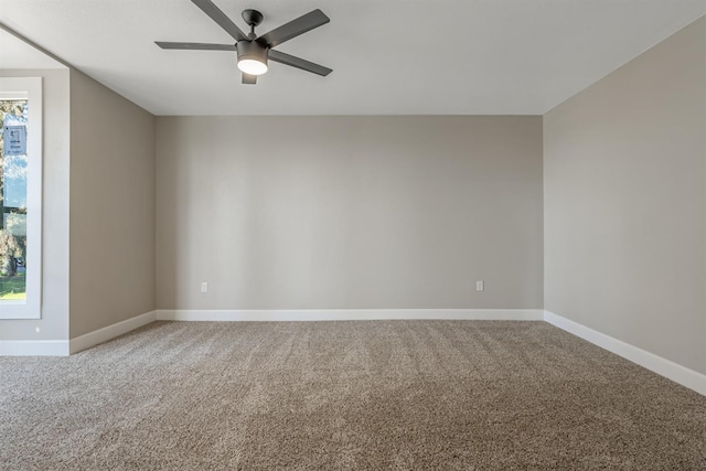 carpeted spare room featuring ceiling fan