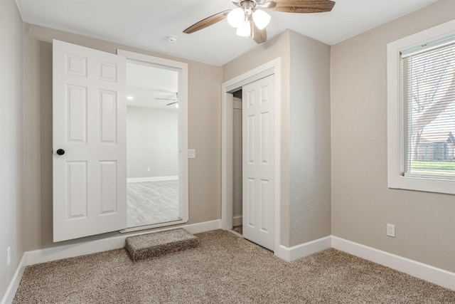 unfurnished bedroom with carpet floors, ceiling fan, and a closet