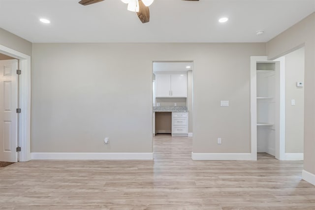 empty room featuring light hardwood / wood-style flooring and ceiling fan