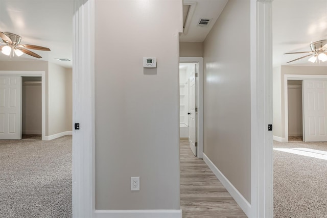 hallway featuring light carpet